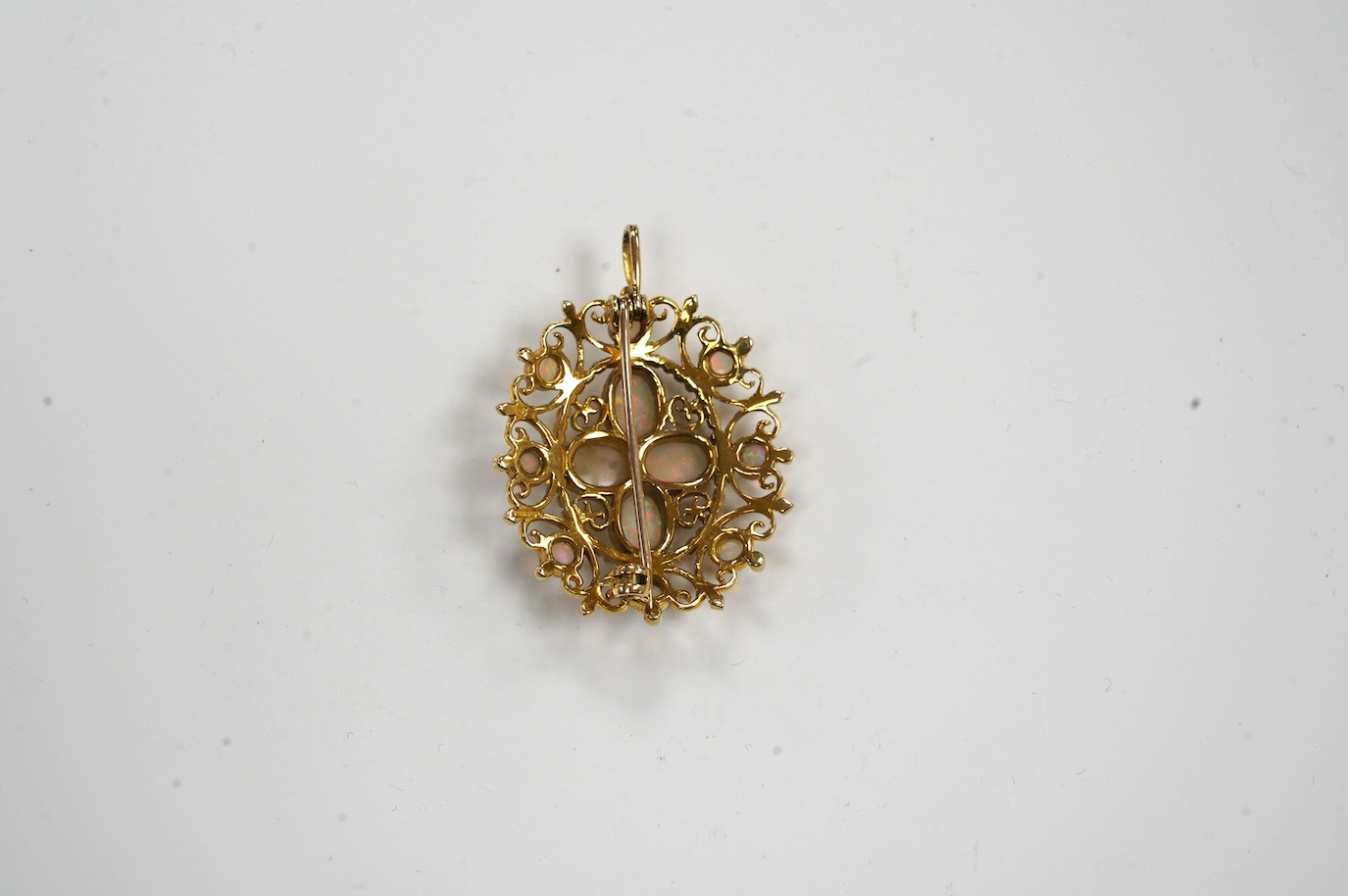 A modern 9ct gold and white opal cluster set oval pendant brooch, 33mm, gross weight 8.7 grams. Condition - fair to good